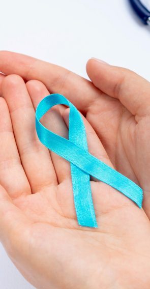 close-up-hands-holding-blue-ribbon-with-stethoscope (1)